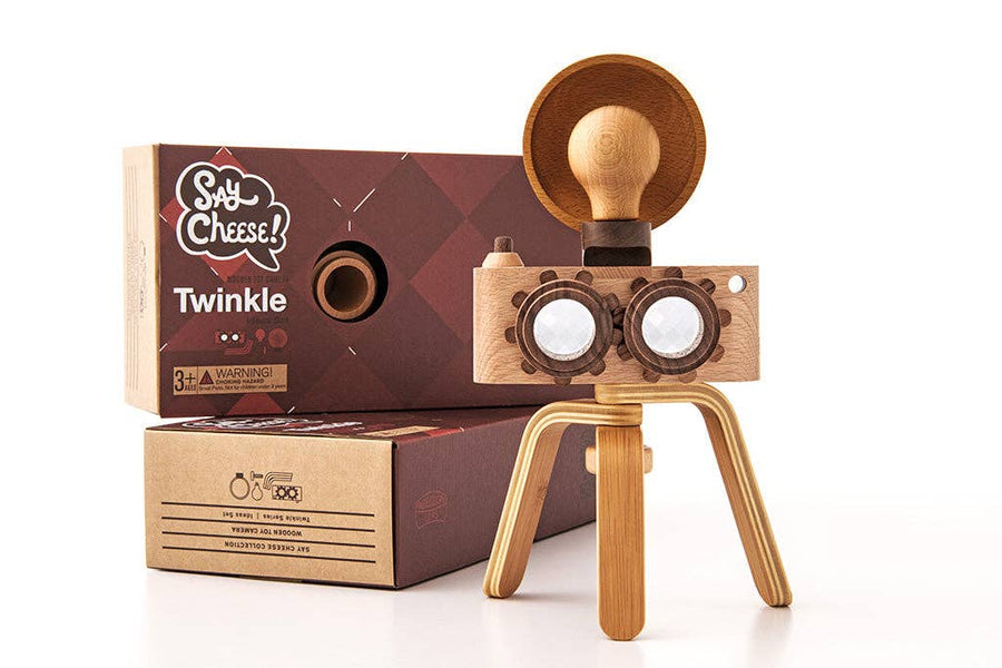 Wooden toy camera with 'Say Cheese' packaging on a white background