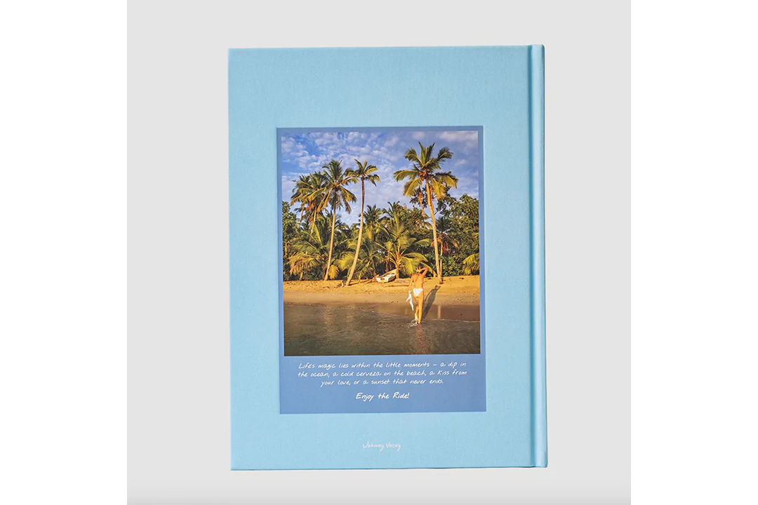 Framed photo of a person walking on a beach with palm trees, featuring a blue border and text.