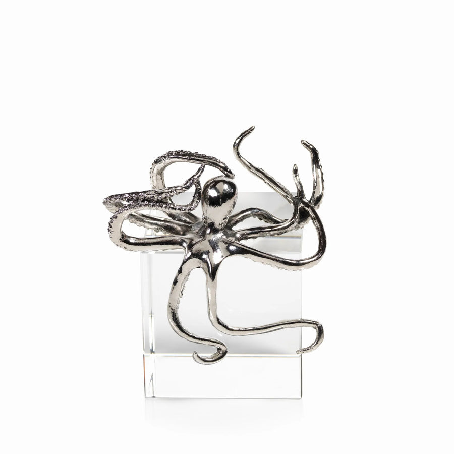 Silver octopus-shaped object on a white background