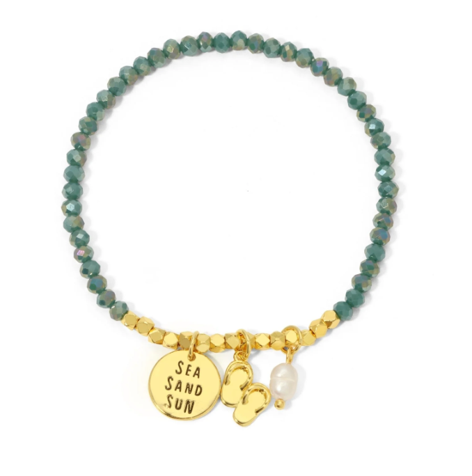 Bracelet with green beads, gold charm, and pearl on a white background
