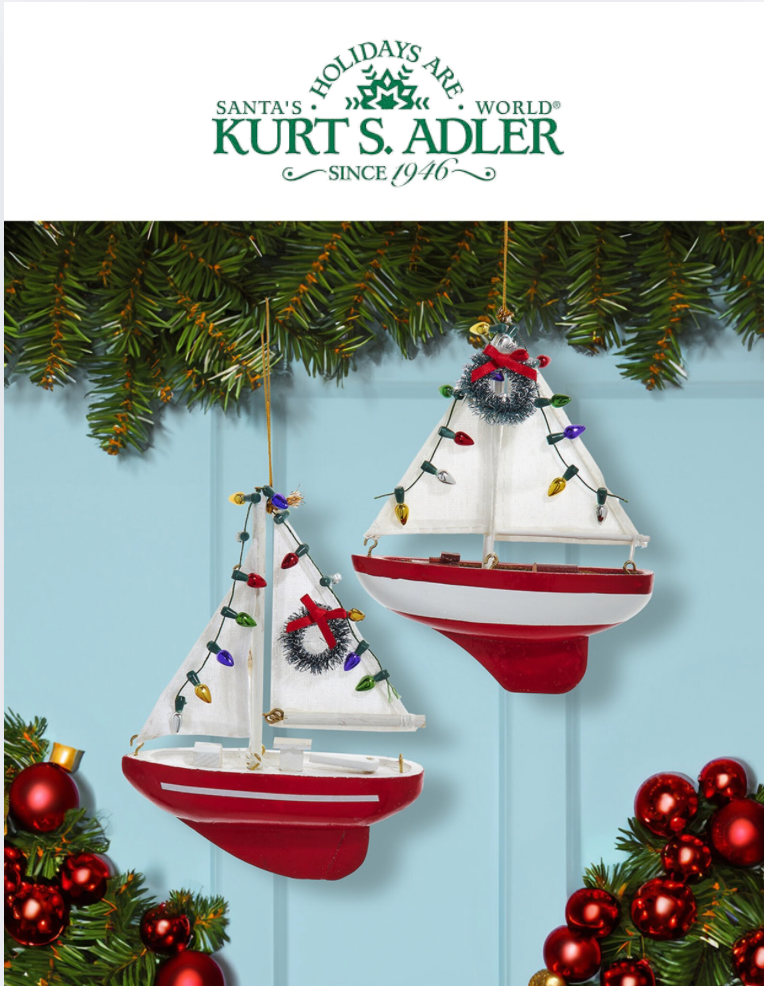 Two sailboat ornaments with Christmas lights and wreaths on a blue background, featuring Kurt S. Adler branding.