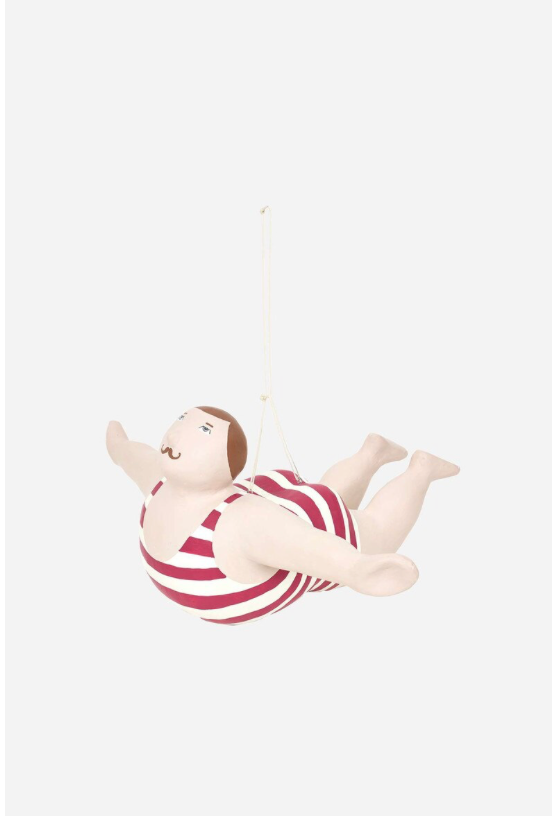Toy figure of a child in a striped swimsuit on a white background