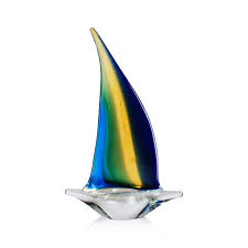 Colorful glass sailboat sculpture on a white background