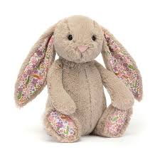 Floral-patterned bunny toy on a white background