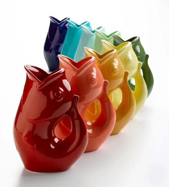 Set of colorful owl-shaped vases on a white background