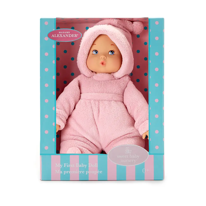 Baby doll in pink outfit with matching hat in packaging