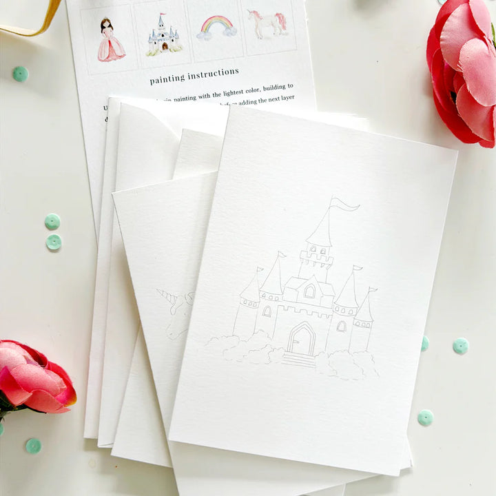 White paper with castle design and painting instructions on a light surface with flowers.