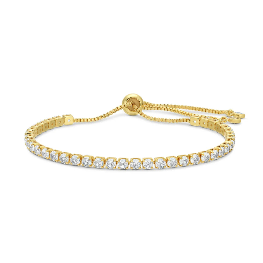 Gold bracelet with clear gemstones on a white background